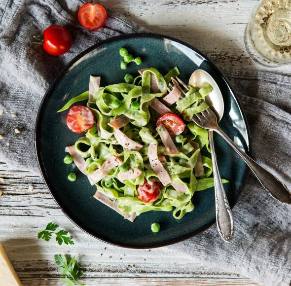 Tagliatelle in Käsesoße mit Schinken und Erbsen