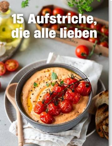 15 Aufstriche, die alle lieben. Eine Schale mit rotem Dip, auf dem Tomaten liegen